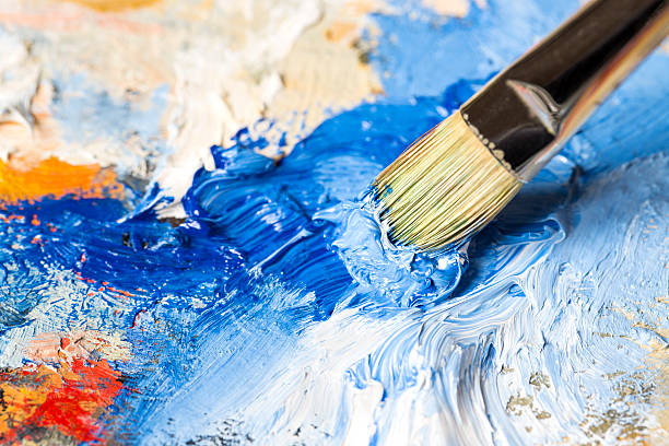 istock Paintbrush with blue oil paint on a classical palette 463260849