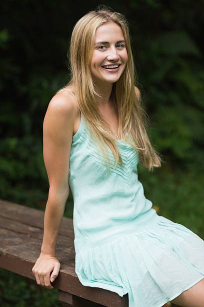 istock Laughing blonde woman sitting on a bench 463261709