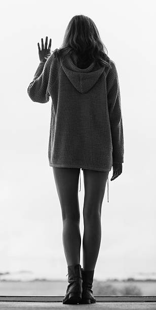 istock Stylish woman standing at the window 463261743
