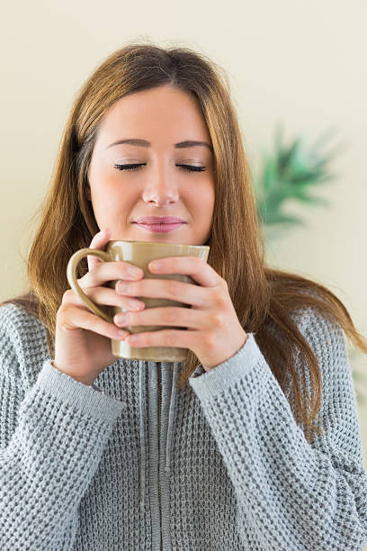 istock Young woman smelling a cup 463261869