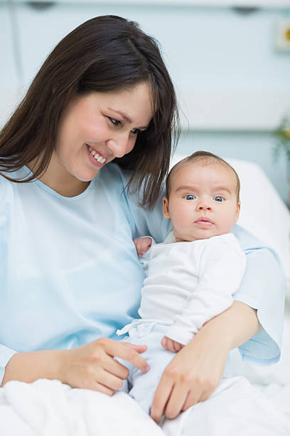 istock Smiling mother looking at a newborn baby 463267377