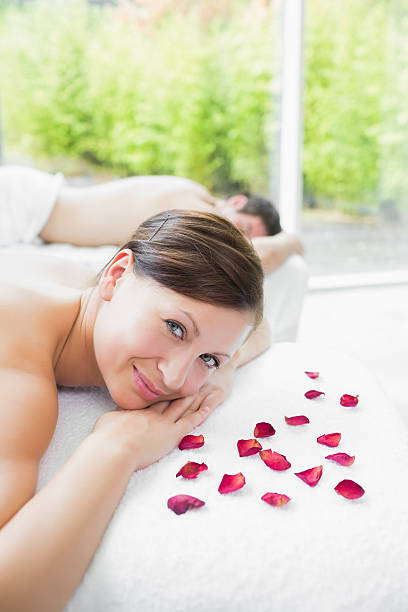 istock Woman smiling next to pink petal 463268187