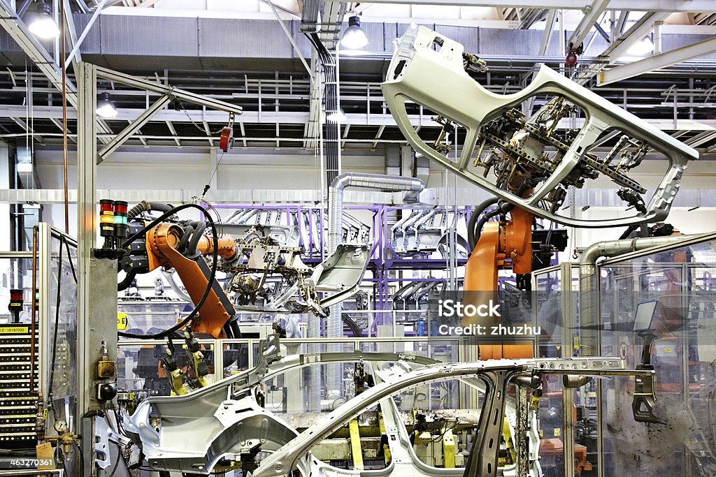 robots in a car factory robotic arms in a car factory Automobile Industry Stock Photo