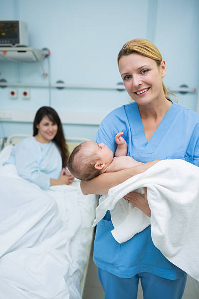 istock Nurse holding a new born baby 463270621