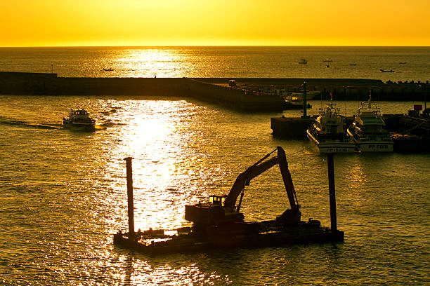 excavator machine строительства на море в сумерках - industrial ship earth mover barge yellow стоковые фото и изображения