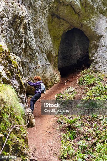 Woman Getting Out From A Cave Stock Photo - Download Image Now - Activity, Adult, Adults Only
