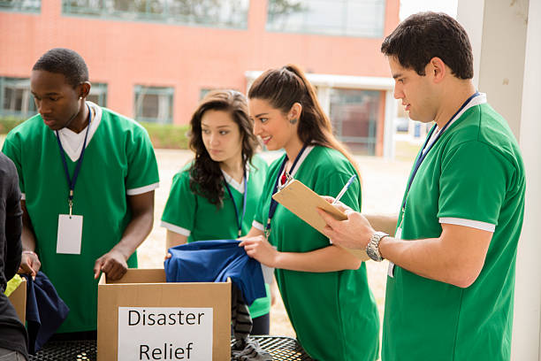 istock Volunteers: College students collect clothing donations. Disaster relief. 463302311