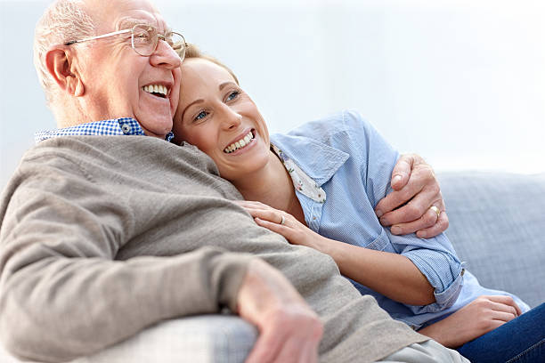 istock Loving father and daughter sitting together on couch 463302373