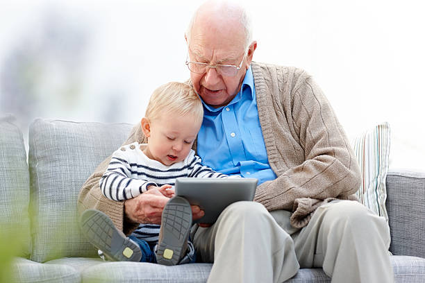 wnuk i jego dziadek za pomocą tabletu pc - grandfather baby grandson grandparent zdjęcia i obrazy z banku zdjęć