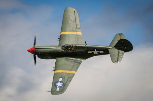 Curtiss P40 Warhawk in flight against blue sky