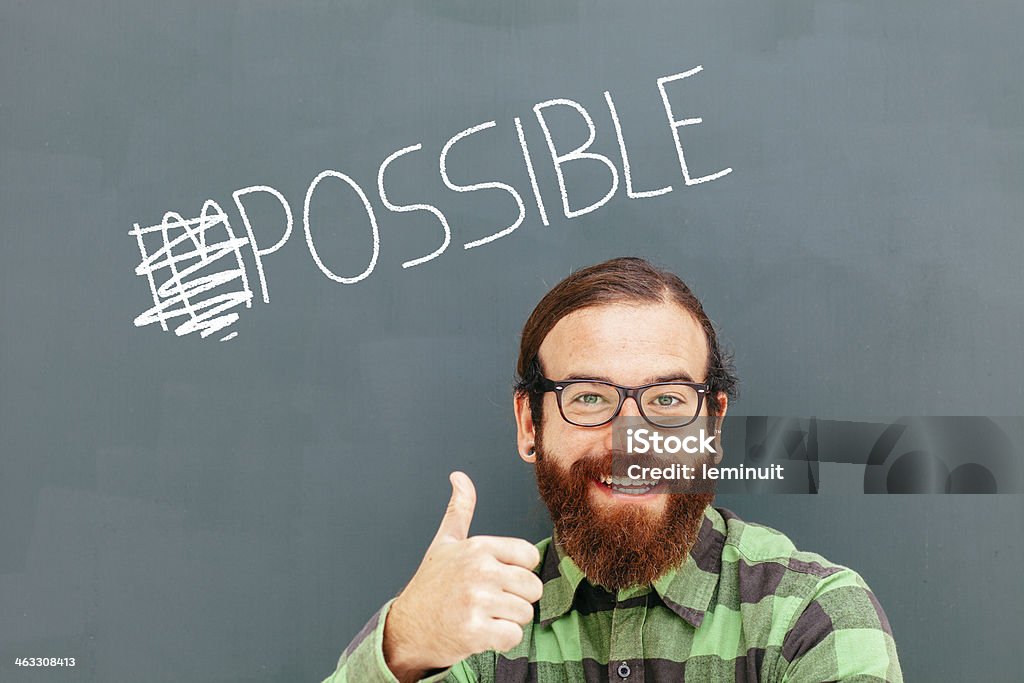 Impossible is nothing A man make a thumb up gesture after turning the word impossible to possible. 30-39 Years Stock Photo