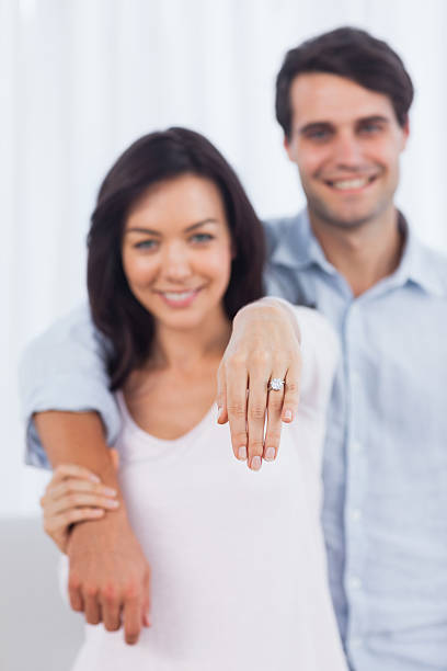 istock Woman showing her engagement ring at camera 463314523