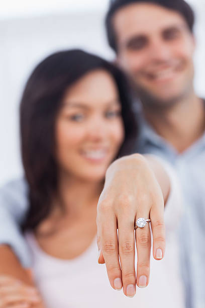 Happy woman showing her engagement ring at camera