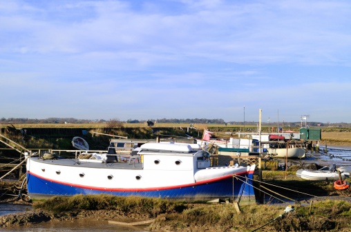 A collection of houseboats on the River Deben at Felixstowe in Suffolk, UK.
