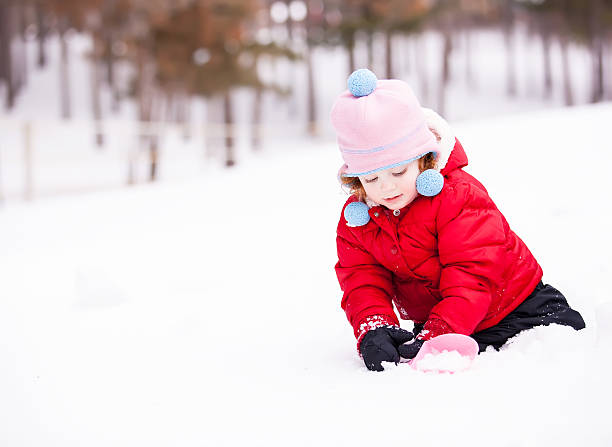 istock Girl Playing in Snow 463315669
