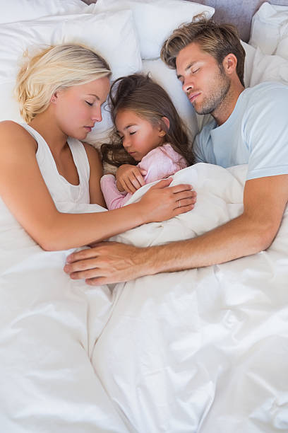istock Parents embracing their daughter 463316401