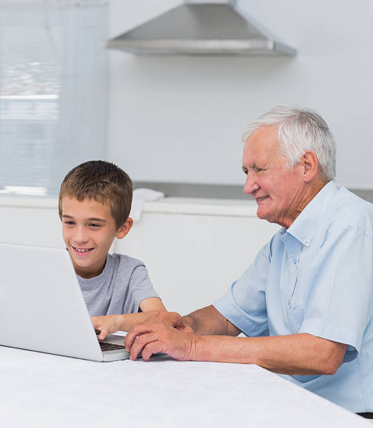 istock Grandson and grandfather using a laptop 463316485