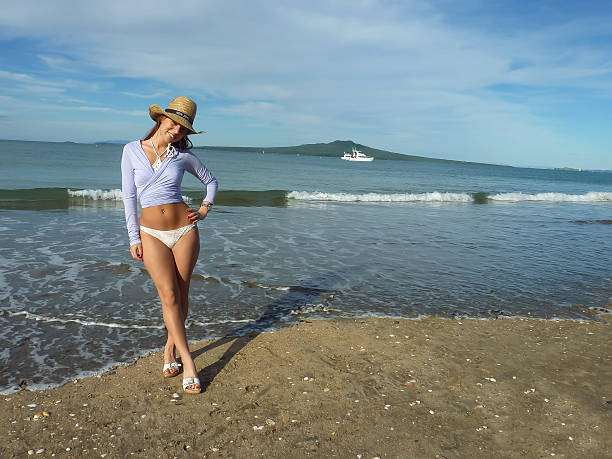 Cheerful New Zealand Girl at Takapuna Beach (2) New Zealand smiling girl enjoys the sun at Takapuna Beach, Auckland (North Shore). rangitoto island stock pictures, royalty-free photos & images