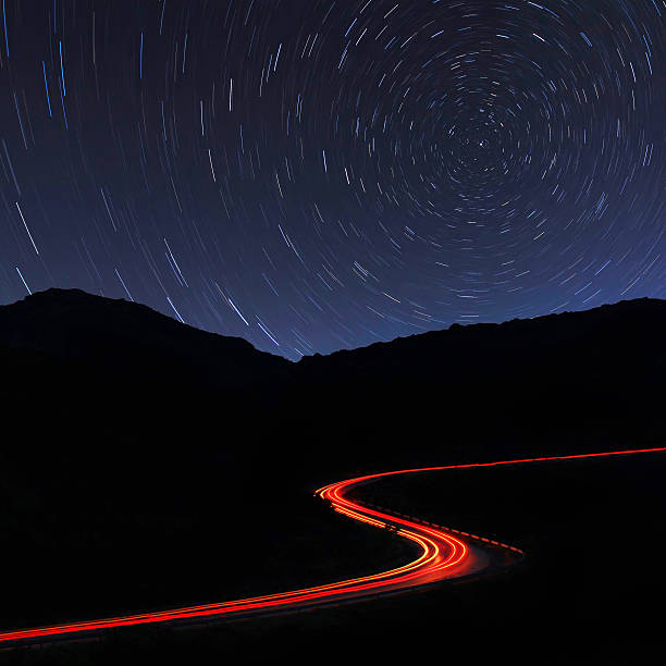 istock Road in the mountains under a starry gyres 463328423