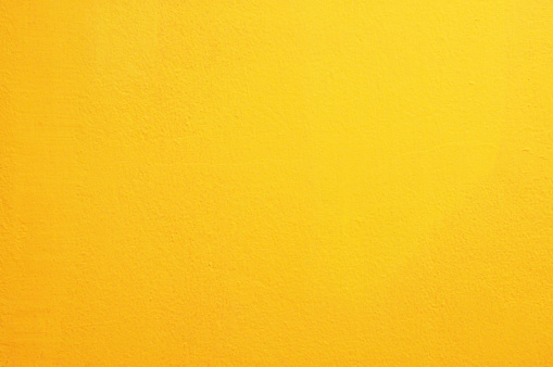 Yellow concrete wall background