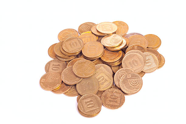 Big heap of small Israeli coins Big heap of small Israeli coins isolated on white background israeli coin stock pictures, royalty-free photos & images