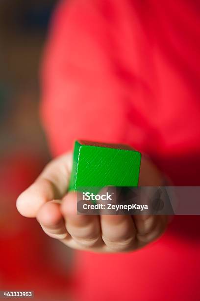 Kid Holding A Green Cube In His Hand Stock Photo - Download Image Now - Architecture, Block Shape, Child