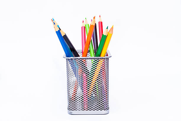 Various color pencils set in black container isolated on white stock photo