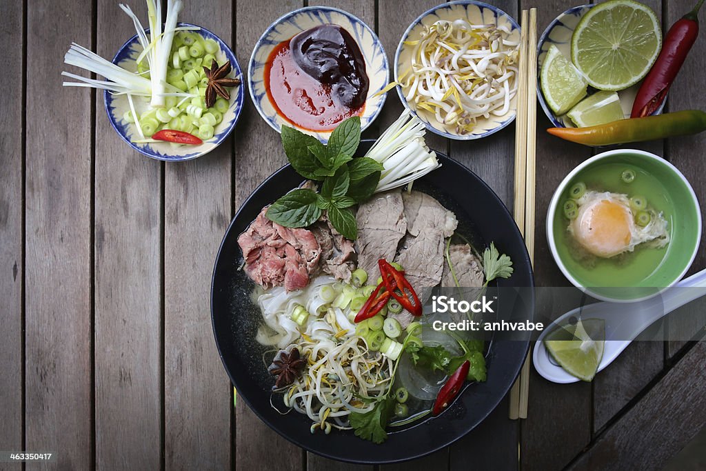Pho, Vietnamese rice noodles Vietnamese rice noodles are served with beef, lime, hoisin sauce and chili sauce and ready to eat. Appetizer Stock Photo