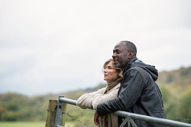 Mature Couple leaning on gate