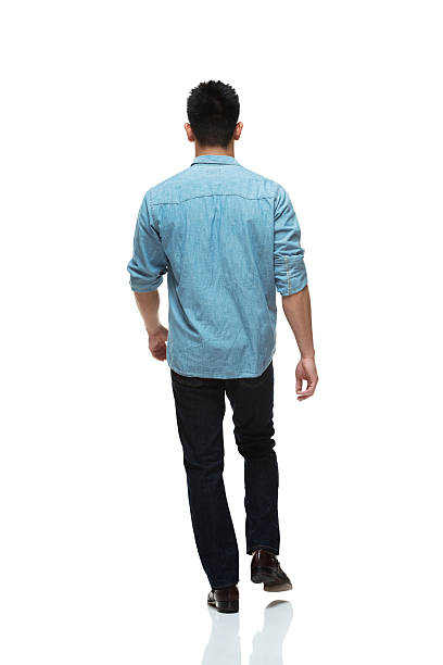 Rear view of young man walking with casual clothes Rear view of young man walking with casual clotheshttp://www.twodozendesign.info/i/1.png rolled up sleeves stock pictures, royalty-free photos & images