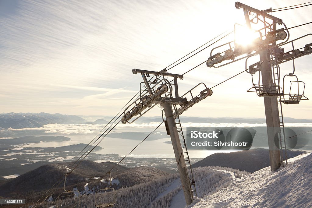 Sun shining brightly at the top of a chairlift The sun is reflecting off of a chairlift tower at Schweizter Mountain Resort in the panhandle of northern Idaho. Below, the city of Sandpoint can be seen on the shores of Lake Pend Oreille. Idaho Stock Photo