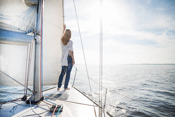 istock woman staying on sailboat 463353483