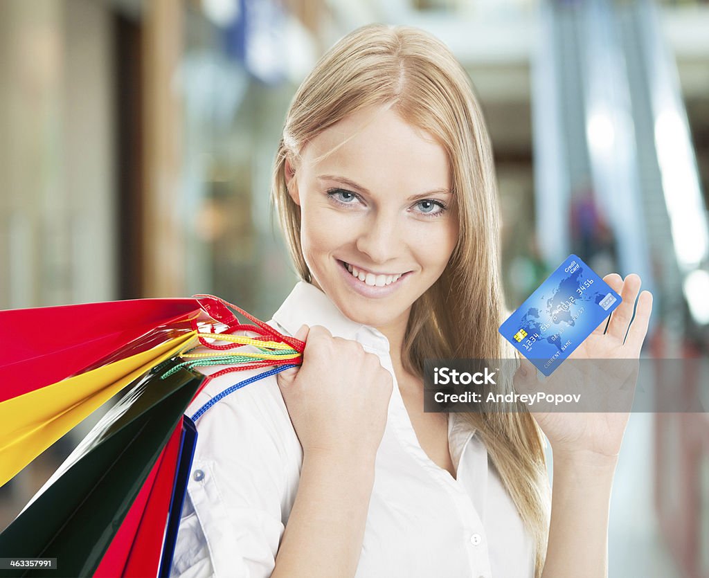 Woman With Bags And Credit Card Beautiful young woman carrying shopping bags. Isolated on white One Woman Only Stock Photo