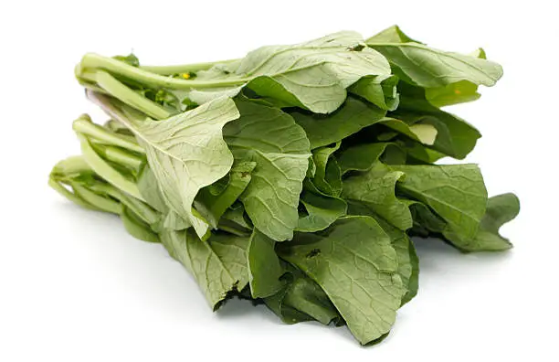 Photo of Bunch of leafy mustard greens isolated on white background