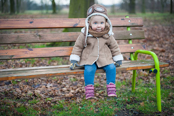 Cute pilot sitting on a bench stock photo