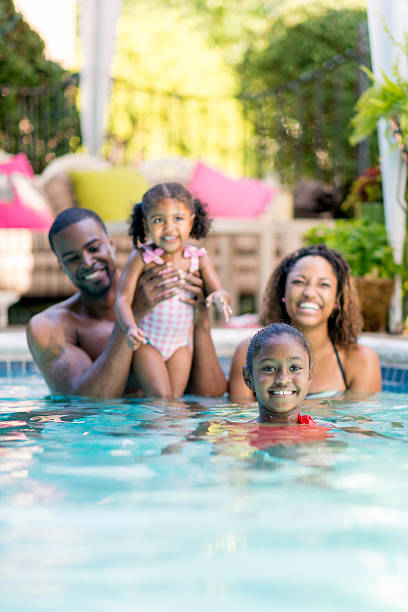 istock family having fun in swimming pool 463374421