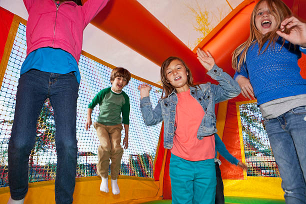 istock Children jumping in bounce house 463375031
