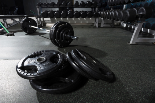 metal barbell on dark gray background