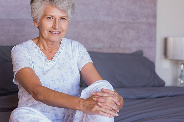 istock Mature woman joining hands on her knee 463375897