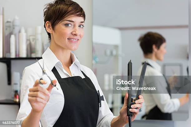Female Hairdresser Holding Scissors And Hair Straightener - zdjęcia stockowe i więcej obrazów 30-39 lat