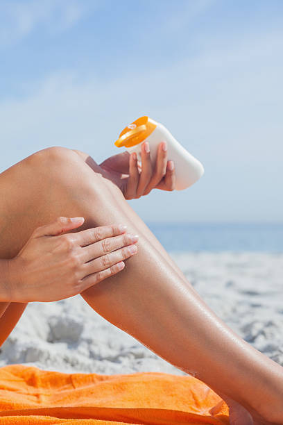 istock Woman putting sunscreen on her leg 463377525