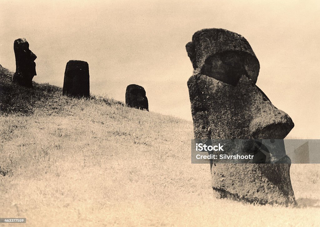 Easter Island Heads buried on a hillside. Scan from a custom made lith print that introduces lots of variables into the process. These Moai are located just downhill from Rano Raraku, and are the most photographed on the island. Art Stock Photo