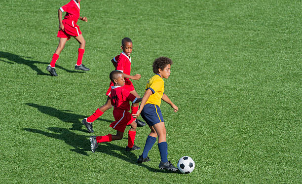 istock Young Boys Playing Football 463378479