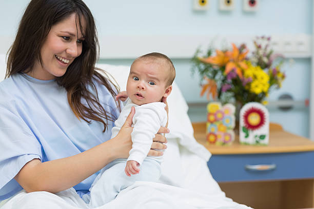 istock Smiling mother showing a new born baby 463382813