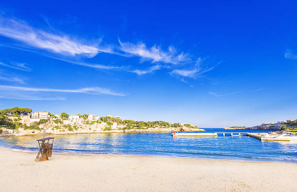 Town beach of Porto Cristo with the harbour right next to it. Porto Cristo is located on the East coast of Mallorca, Spain