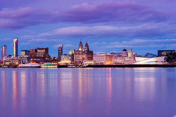 UK Liverpool England Waterfront City Skyline at Dusk This is a horizontal, color photograph of Liverpool England at dusk. The docks are visible along the city skyline across the River Mersey.http://i256.photobucket.com/albums/hh165/Dakandikid/Istock%20banners/banners_UK.jpg?t=1396189379 estuary photos stock pictures, royalty-free photos & images