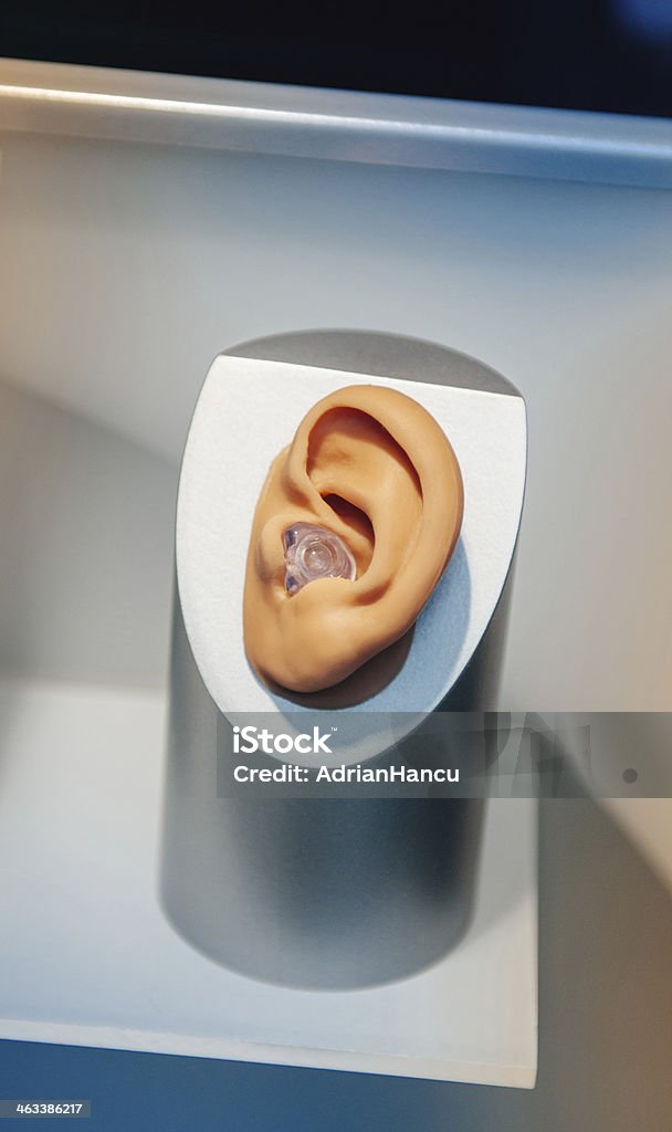 Hearing aid Hearing aid close-up placed inside the model of a human ear Assistance Stock Photo