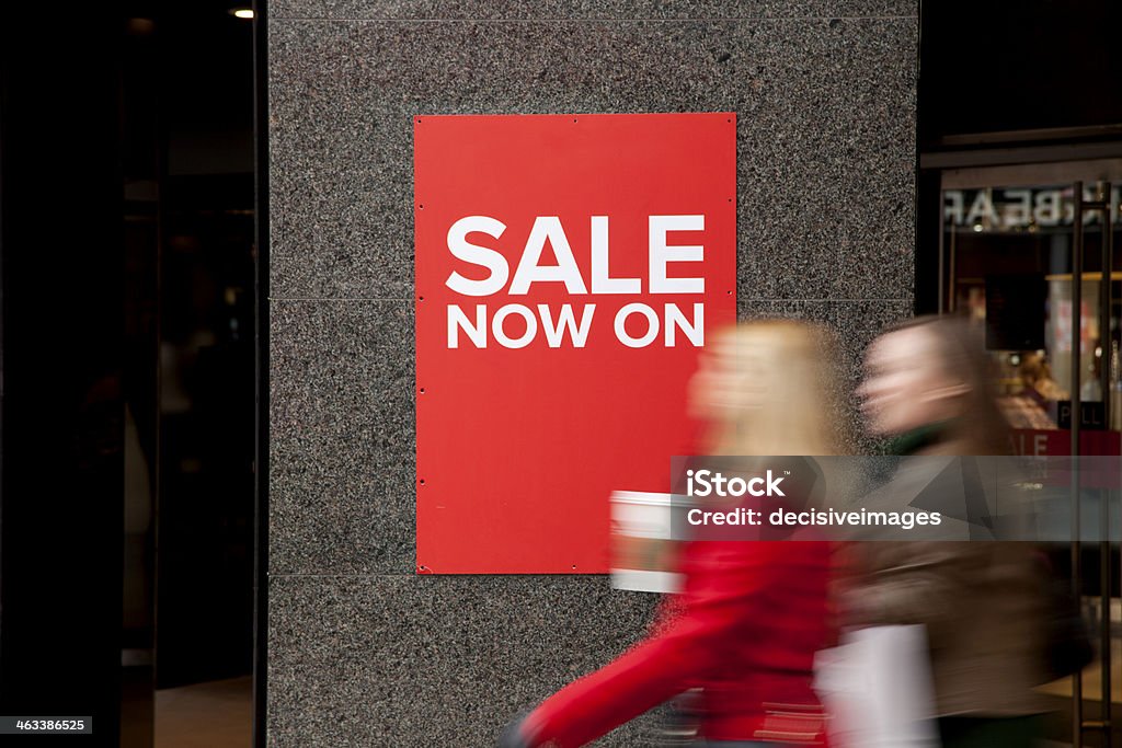 Looking for a bargain Two female friends on their way to the sales in a department store. Sign Stock Photo