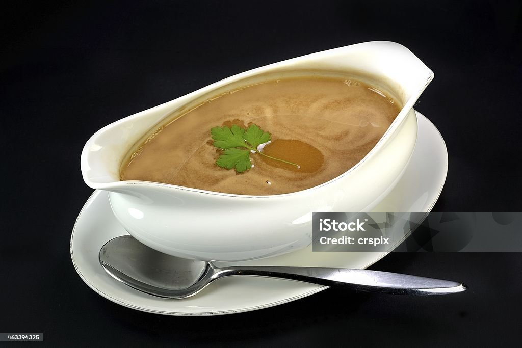 Gravy bowl Gravy in a bowl with parsley and a spoon. Bowl Stock Photo