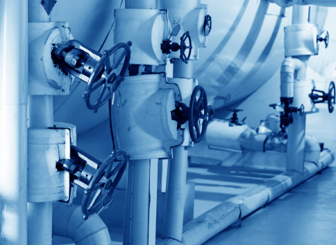 Closeup of manometer, pipes and faucet valves of heating system in a boiler room